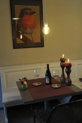 a table with two candles and wine glasses on it at Luttelkolen in Holsbeek