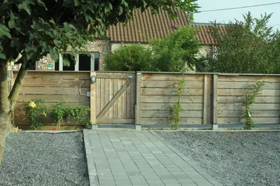 a wooden fence in front of a house at Luttelkolen in Holsbeek