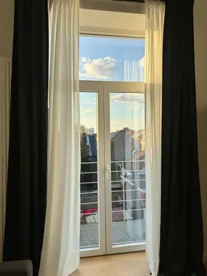 a window with a view of a balcony at Bora Apartment in Brussels