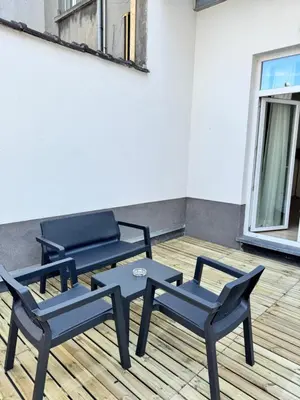 a patio with two chairs and a table at MIDI cozy apartment in Brussels
