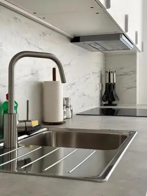 a stainless steel kitchen sink in a kitchen at MIDI cozy apartment in Brussels