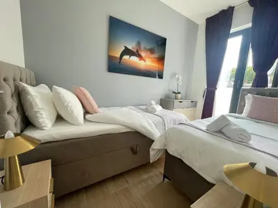 a bedroom with two beds and a painting on the wall at OneLuxStay near Antwerp Central in Antwerp