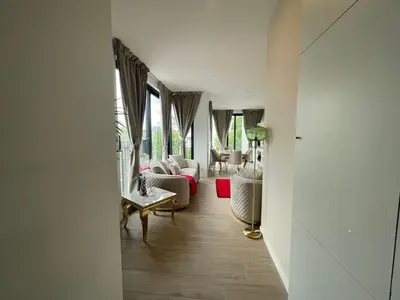 a living room with a couch and chairs and windows at OneLuxStay near Antwerp Central in Antwerp