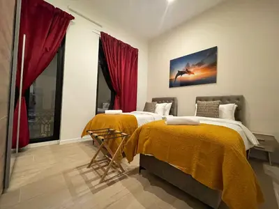 two beds in a room with red curtains at OneLuxStay near Antwerp Central in Antwerp
