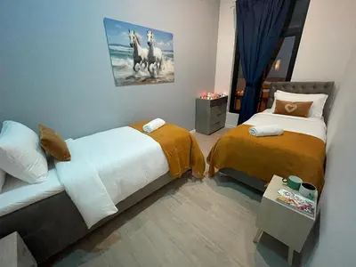 a bedroom with two beds and a picture of horses at OneLuxStay near Antwerp Central in Antwerp