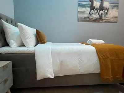 a bed with white sheets and pillows in a bedroom at OneLuxStay near Antwerp Central in Antwerp
