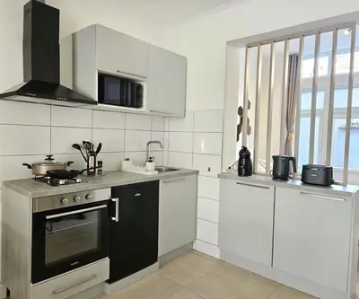 a kitchen with white cabinets and a stove top oven at Proche du centre de Bruxelles, Atomium,Tour&Taxi,ING Arena in Brussels