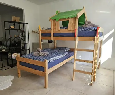 two bunk beds in a room with a ladder at Proche du centre de Bruxelles, Atomium,Tour&Taxi,ING Arena in Brussels