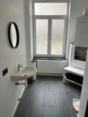 a bathroom with a sink and a window at Flat south Brussels in Brussels