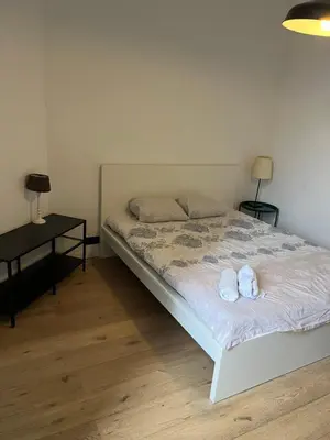 a bedroom with a bed with two stuffed animals on it at Flat south Brussels in Brussels