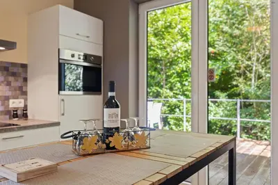 a bottle of wine sitting on a table in a kitchen at Chalet & Spa Nora in Stekene