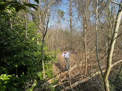 a man is standing in the woods at Chalet & Spa Nora in Stekene