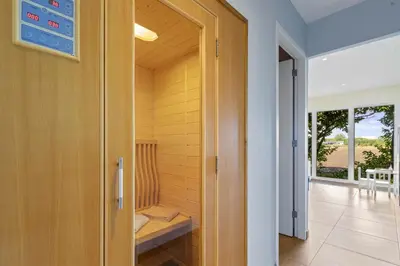 a room with a sauna with a bench in it at Chalet & Spa Nora in Stekene