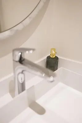 a bathroom sink with a faucet and a mirror at Apartment in the hyper-center in Brussels