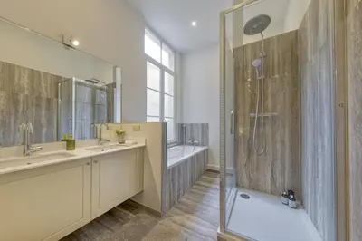 a bathroom with two sinks and a shower at Apartment in the hyper-center in Brussels