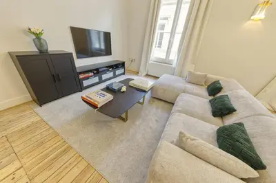 a living room with a couch and a tv at Apartment in the hyper-center in Brussels