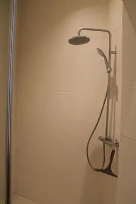 a shower with a shower head in a bathroom at The Antwerp Cathedral suite first floor in Antwerp