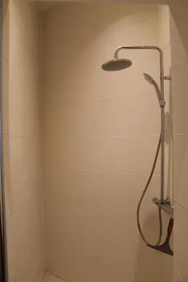 a shower with a shower head in a bathroom at The Antwerp Cathedral suite first floor in Antwerp