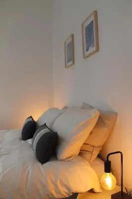 a bed with pillows on it in a bedroom at The Antwerp Cathedral suite first floor in Antwerp