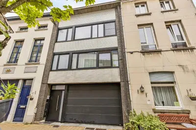 an apartment building with a garage at Huis ALNA 8 in Mechelen