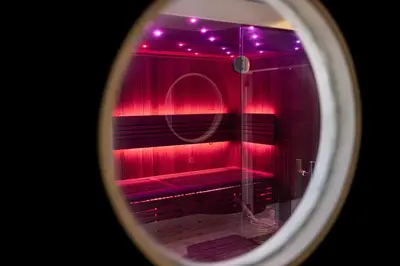 a room with red lights and a red bench at Blvck Spa in Brussels