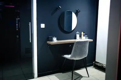 a blue bathroom with a chair and a mirror at Blvck Spa in Brussels