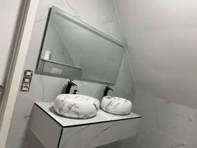 a white bathroom with a sink and a mirror at Villa op de hoek Rooms in Aalst