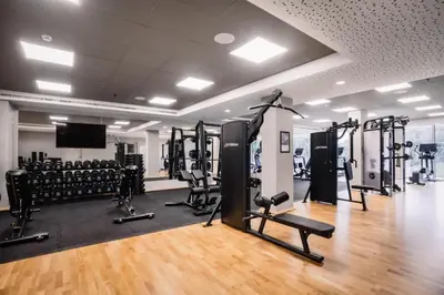 a gym with lots of treadmills and machines at Hilton Garden Inn Brussels Airport in Diegem