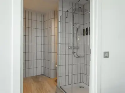 a shower with a glass door in a bathroom at Hilton Garden Inn Brussels Airport in Diegem
