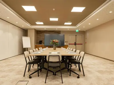 a large conference room with a long table and chairs at Hilton Garden Inn Brussels Airport in Diegem