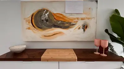 a living room with a table with a painting on the wall at Artist's Nest apartment in Antwerp
