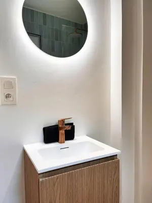 a bathroom with a sink and a mirror at Artist's Nest apartment in Antwerp