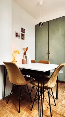 a dining room with a white table and chairs at Artist's Nest apartment in Antwerp