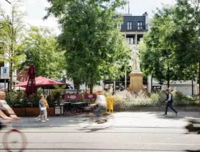 a person riding a skateboard in a park with a fountain at Artist's Nest apartment in Antwerp