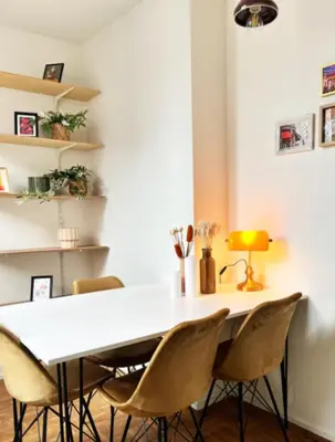 a dining room with a white table and chairs at Artist's Nest apartment in Antwerp