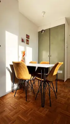 a dining room with a table and chairs at Artist's Nest apartment in Antwerp