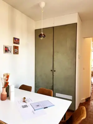 a dining room with a white table and chairs at Artist's Nest apartment in Antwerp