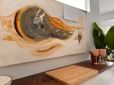 a painting hanging on a wall next to a table at Artist's Nest apartment in Antwerp