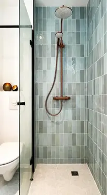 a bathroom with a glass shower with a toilet at Artist's Nest apartment in Antwerp