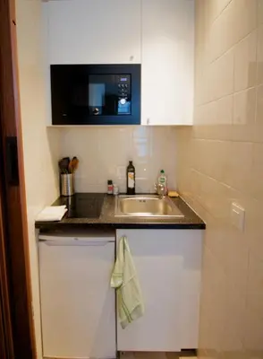 a small kitchen with a sink and a counter at Beautiful and bright apt AvLouise in Brussels