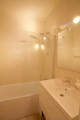a bathroom with a shower and a sink and a tub at Beautiful and bright apt AvLouise in Brussels