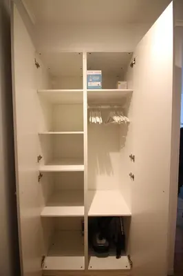 a closet with white shelves in a room at Beautiful and bright apt AvLouise in Brussels