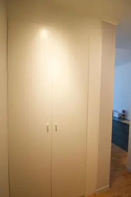 a closet with white doors in a room at Beautiful and bright apt AvLouise in Brussels
