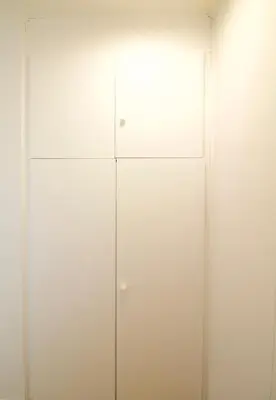 a white closet with white doors in a room at Brand new & cosy - Louise & Stéphanie area in Brussels