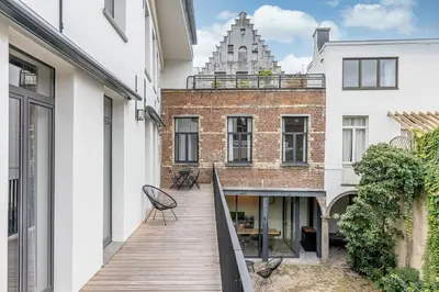 a balcony of a building with a wooden deck at Beautiful spacious Loft in the Heart of Antwerp in Antwerp