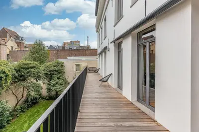 a wooden walkway with a bench on the side of a building at Beautiful spacious Loft in the Heart of Antwerp in Antwerp