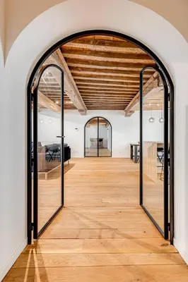 an open door to a room with a wooden floor at Beautiful spacious Loft in the Heart of Antwerp in Antwerp