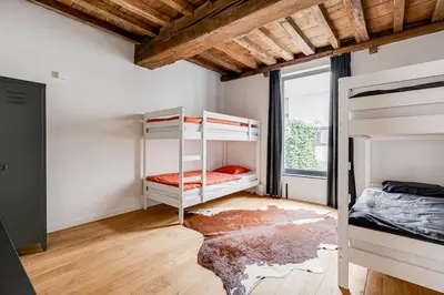 a bedroom with two bunk beds and a window at Beautiful spacious Loft in the Heart of Antwerp in Antwerp