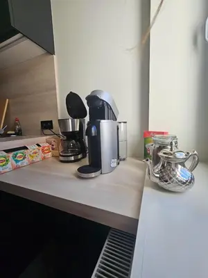 a counter top with a coffee maker on it at L' Gante in Ghent