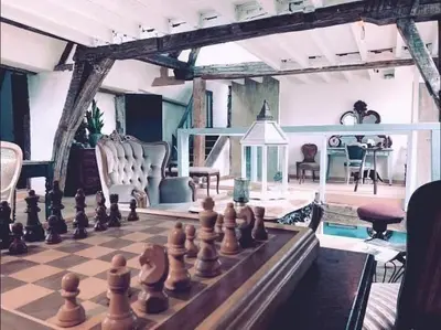 a chessboard is sitting on a table in a room at The Lofty Mystic's Lodge in Antwerp